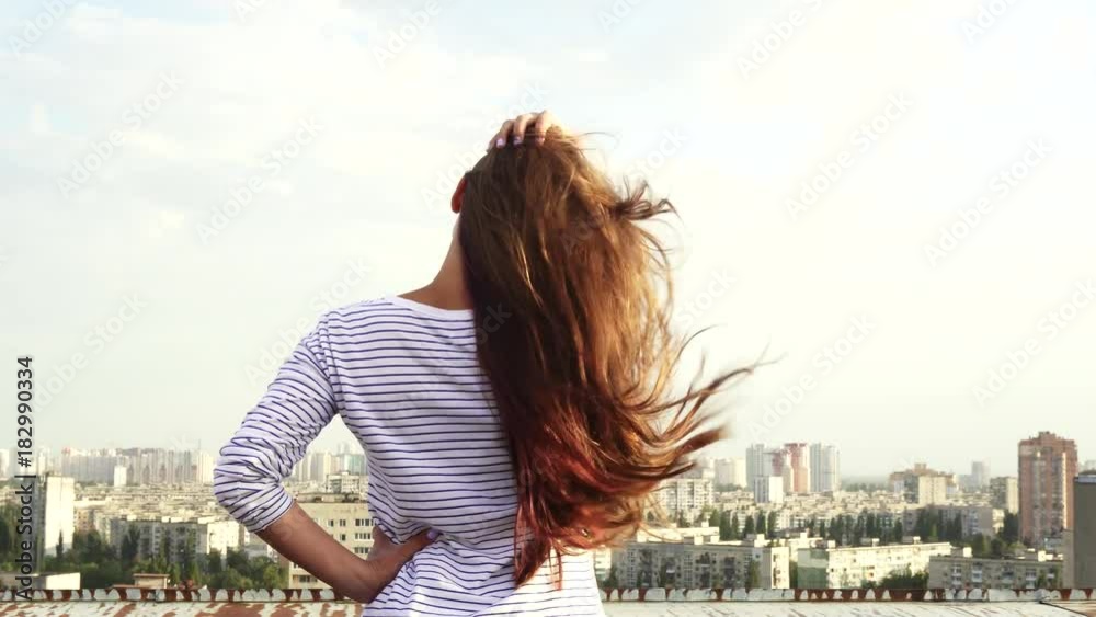 Back view of the girl and the panorama of the city Back view of the girl and the panorama of the city