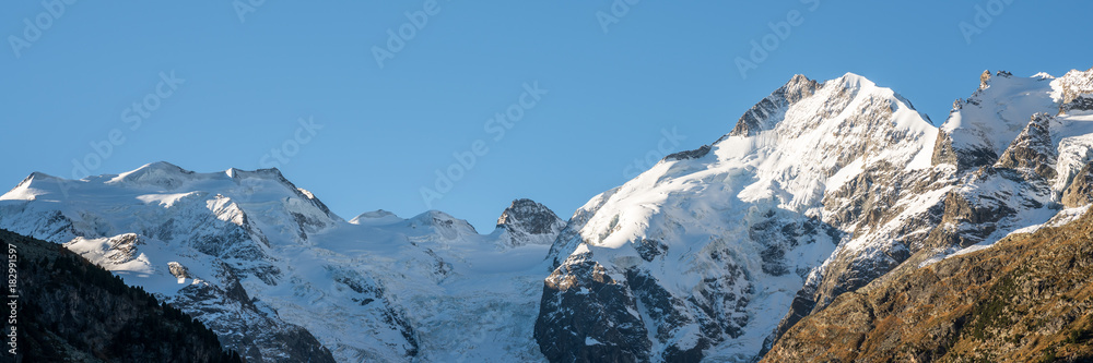 white snow-covered mountain peaks of the Bernina mountain range in the Morteratsch Valley near St. Moritz in the Swiss Alps white snow-covered mountain peaks of the Bernina mountain range in the Morteratsch Valley near St. Moritz in the Swiss Alps