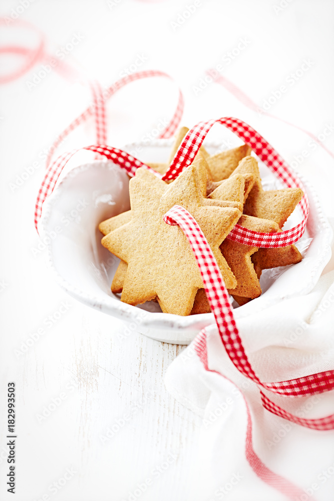 Gingerbread cookies with check ribbon in a bowl Gingerbread cookies with check ribbon in a bowl