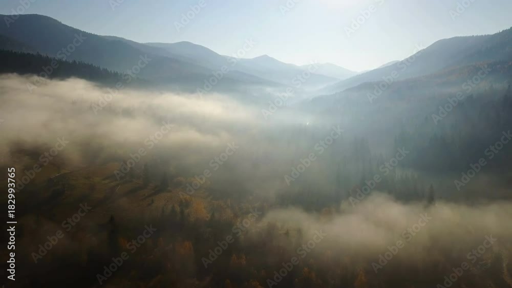 Aerial view of the field at mountains with a morning fog Aerial view of the field at mountains with a morning fog