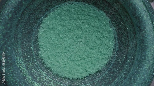 Subwoofer Audio Speaker Vibrations with Glitter, Colors and Sparkles. Overhead Shot.