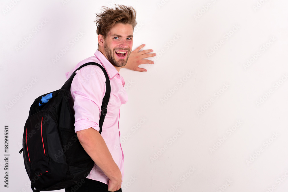 Young man backpacker walking in studio Young man backpacker walking in studio