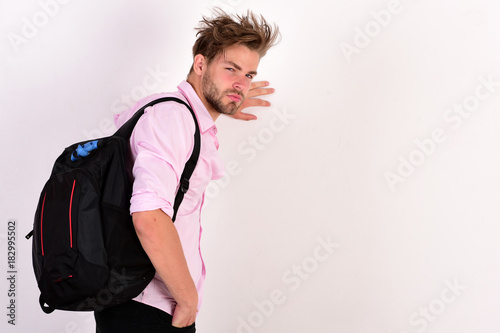 Guy in pink shirt with rucksack on shoulder. Education concept