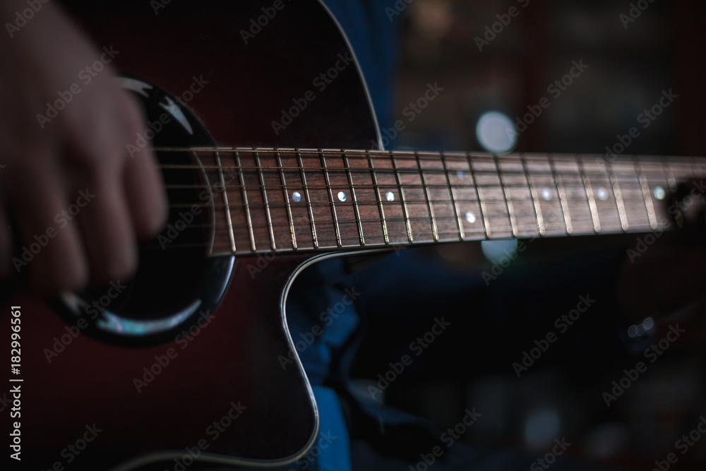 the guy playing the acoustic guitar, closeup, music concept the guy playing the acoustic guitar, closeup, music concept