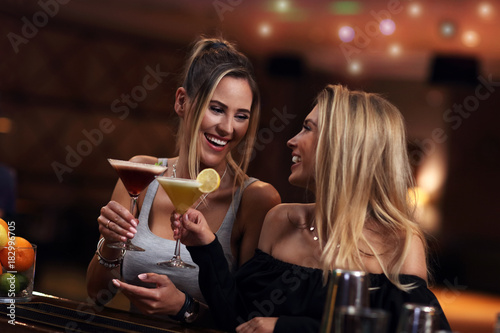 Group Of Friends Enjoying Drink in Bar photo