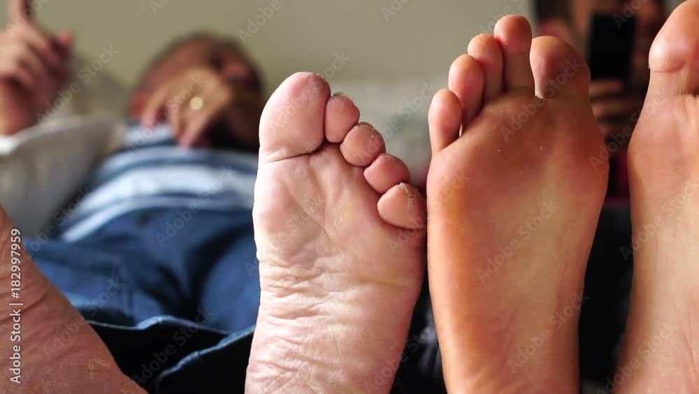 Feet of Friends/Father and Son playing on the bed Feet of Friends/Father and Son playing on the bed