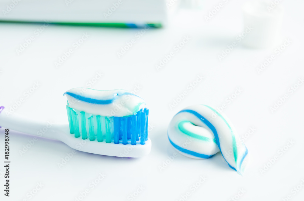 A tube of toothpaste and a toothbrush on white background A tube of toothpaste and a toothbrush on white background