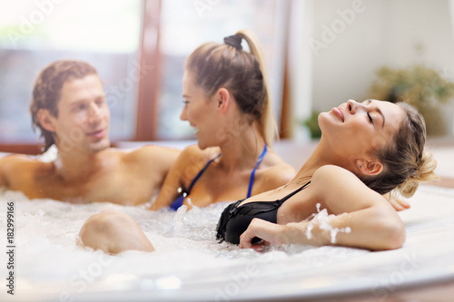 Group of friends enjoying jacuzzi in hotel spa