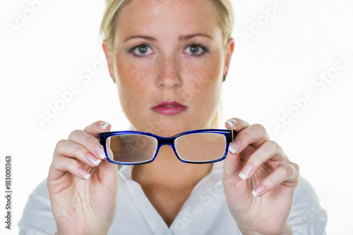woman is holding a pair of glasses photo