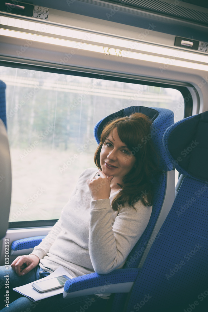 Caucasian woman traveling by train