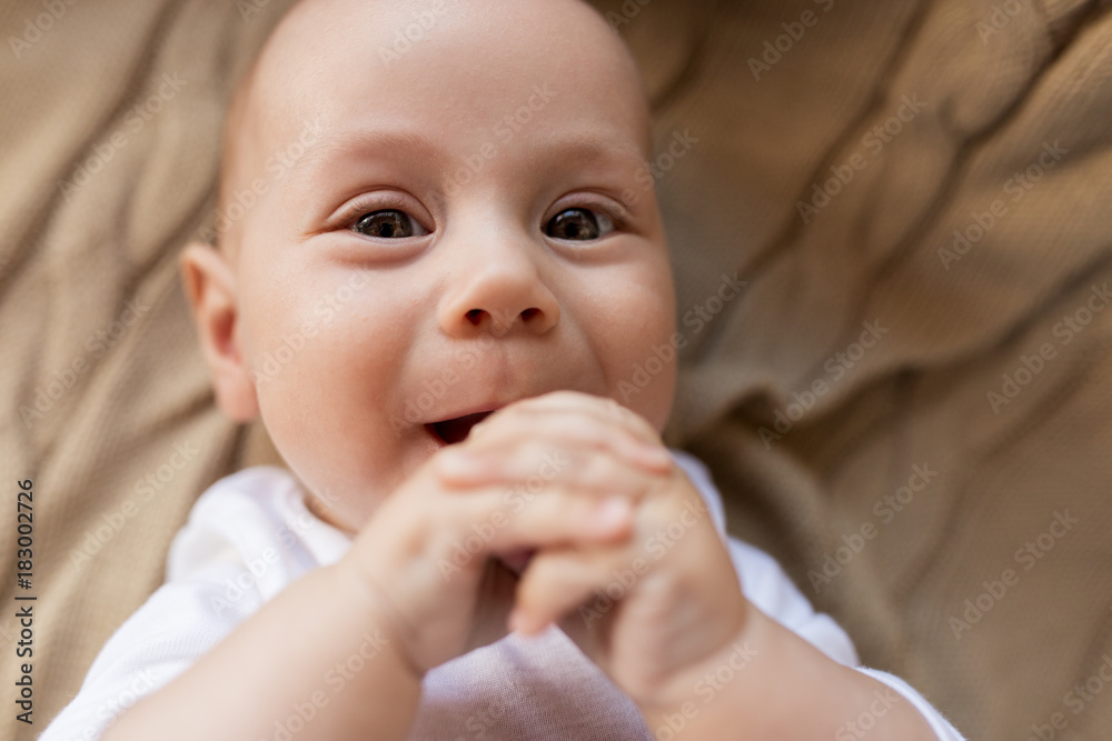 close up of sweet little baby boy lying on blanket close up of sweet little baby boy lying on blanket