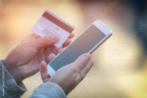 Paying with smartphone and credit card outdoor