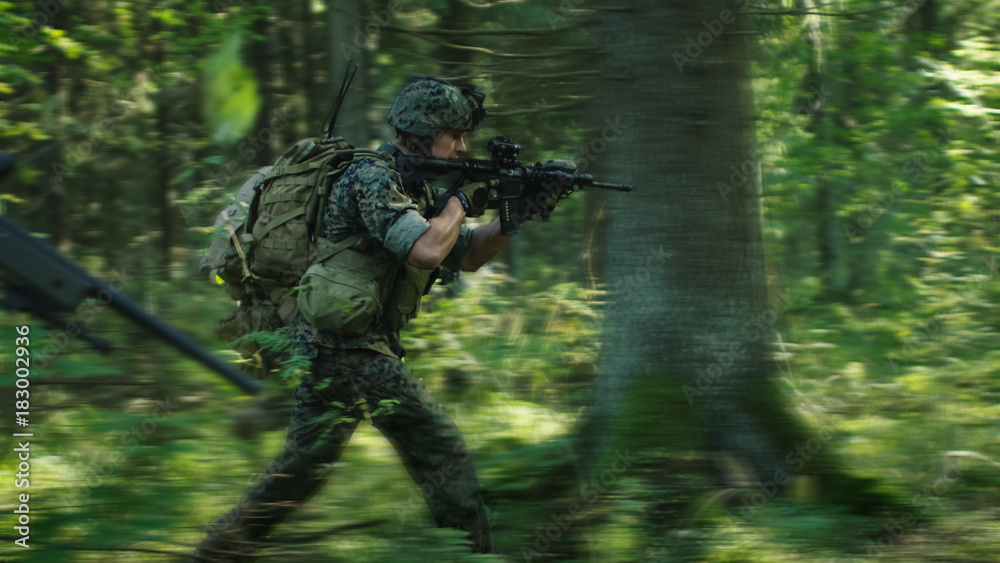 Squad of Fully Equipped Soldiers in Camouflage on a Reconnaissance Military Mission, Rifles in Firing Position. They're Running in Formation Through Dense Forest. Blurred Motion.