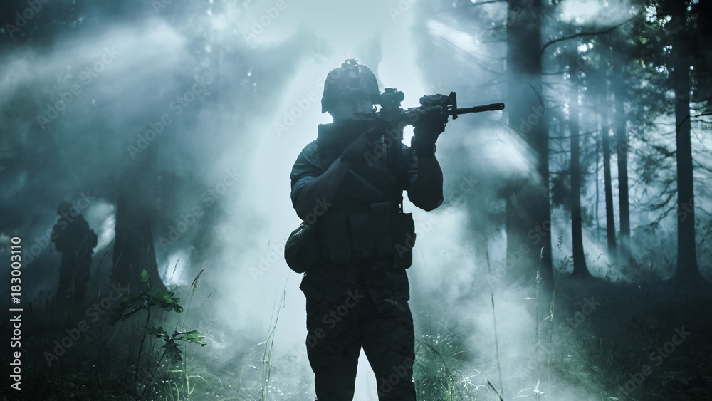 © Gorodenkoff - Silhouette of the Fully Equipped Soldier Moving Through Smokey Forest with Rifle Ready To Shoot. Reconnaissance Military Operation. Squad Moving Behind Him. Dark and Cold Ambient. © Gorodenkoff - Silhouette of the Fully Equipped Soldier Moving Through Smokey Forest with Rifle Ready To Shoot. Reconnaissance Military Operation. Squad Moving Behind Him. Dark and Cold Ambient.