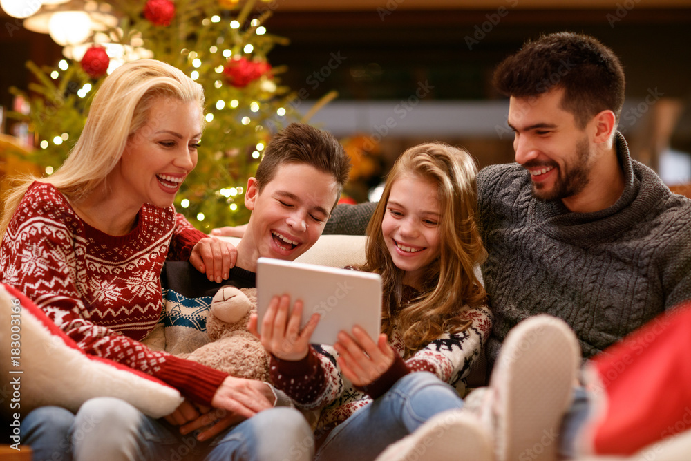 Happy family together having fun while watching photos Happy family together having fun while watching photos