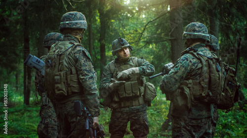 Squad Leader Discusses Military Operation Details with Soldiers, Commander Gives Orders. Fully Equipped and Armed Soldiers Ready for Mission in a Dense Forest.