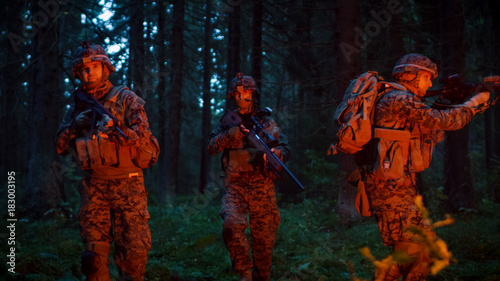 Obraz na plátně Squad of Five Fully Equipped Soldiers in Camouflage on a Reconnaissance Military Night Mission
