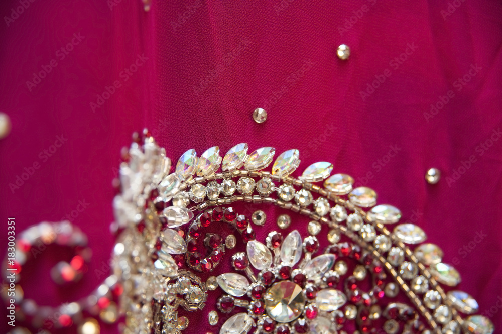 Asian pattern with precious stones on red fabric Asian pattern with precious stones on red fabric
