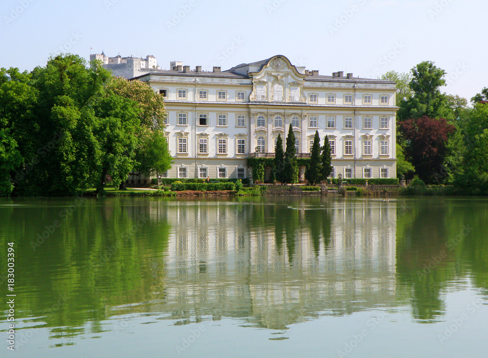 Reflections of Leopoldskron Palace and Hohensalzburg Fortress on the Lake Leopoldskroner Weiher, Salzburg, Austria
