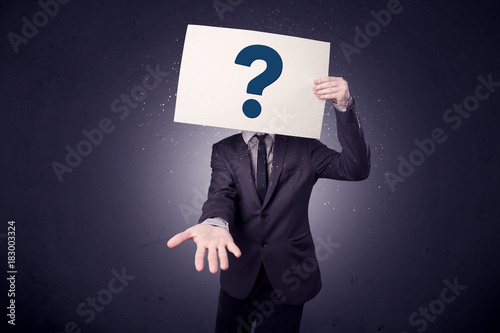 Businessman holding paper with question marks