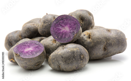 Vitelotte potatoes isolated on white background heap of sliced and whole purple. photo