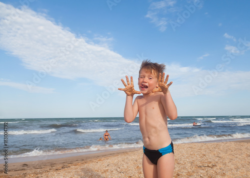 Happy boy having fun on the background of sea