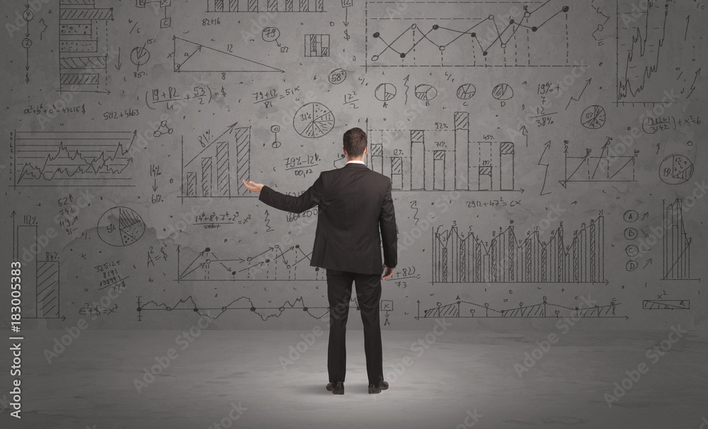 Salesman with business charts on wall Salesman with business charts on wall