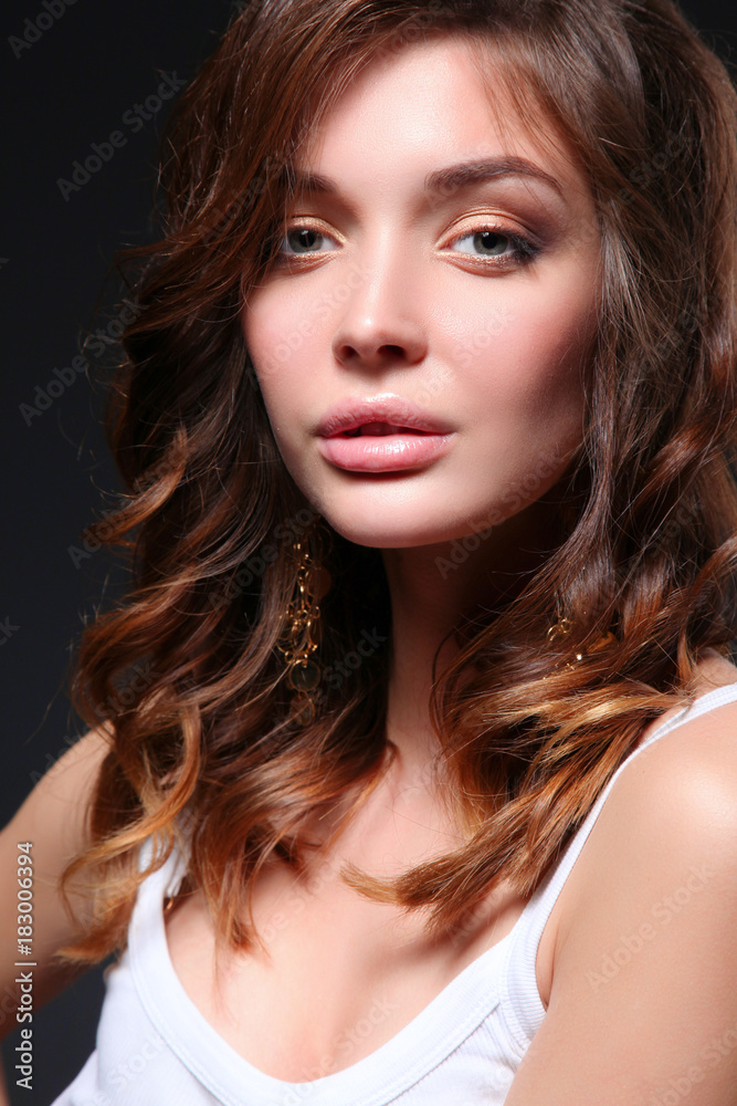 Portrait of beautiful young woman face. Isolated on dark background. Portrait of beautiful young woman face. Isolated on dark background.