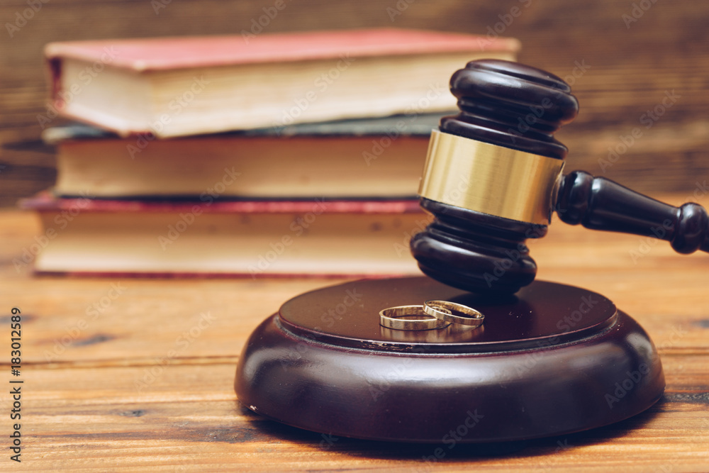Wooden judge gavel and golden rings,  divorce concept