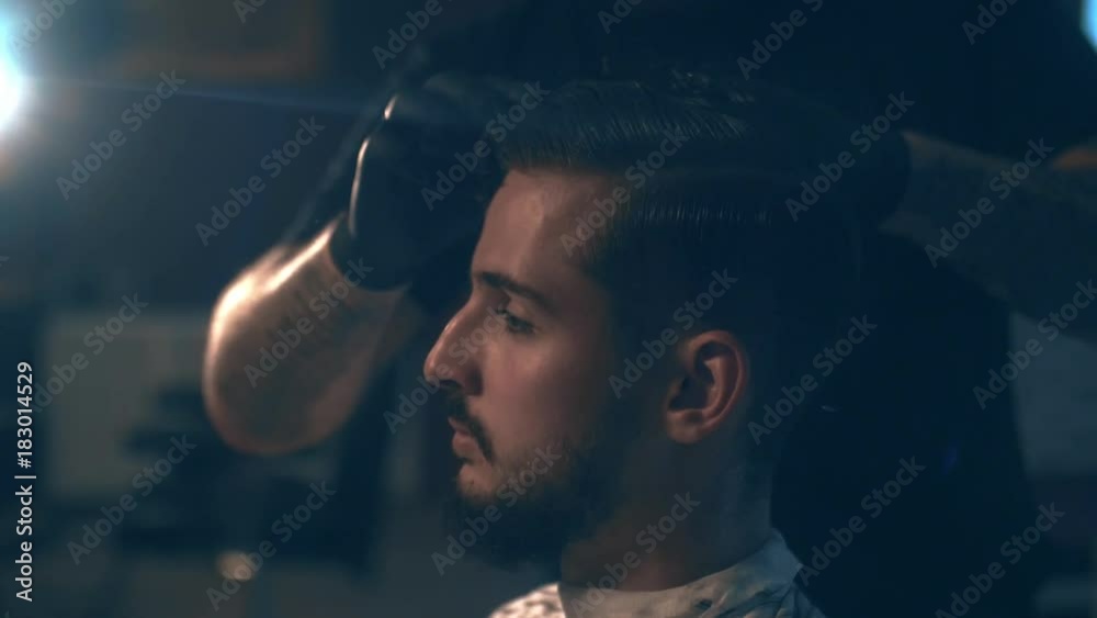 Barbershop. Close-up of a man's haircut, the master does the hair styling