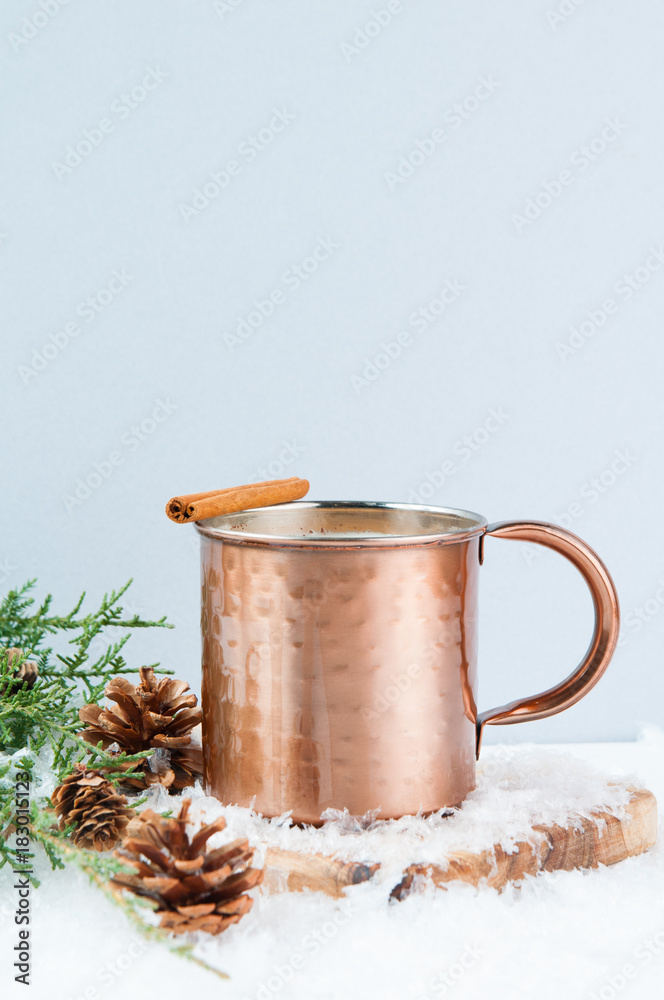 Eggnog in a copper mug with snow seasonal decorations Eggnog in a copper mug with snow seasonal decorations