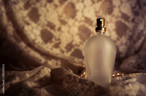 perfume bottle on guipure fabric