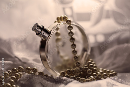 Perfume in a glass bottles and pearl beeds photo