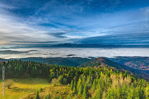 Fototapeta Naklejka Na Ścianę i Meble -  Misty sunrise landscape from Luban peak in Gorce mountains, Poland