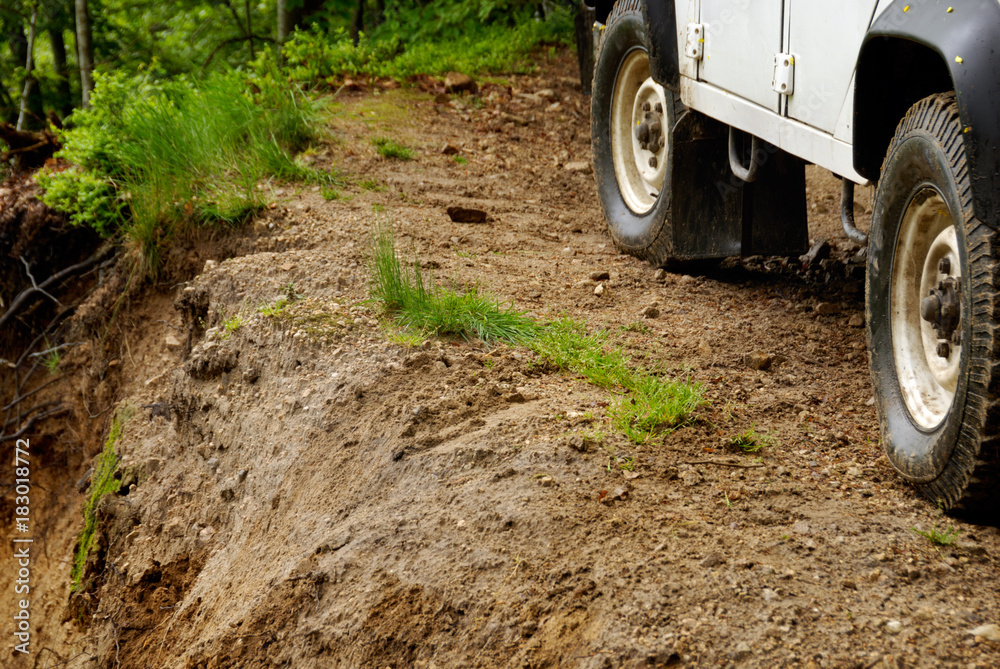 4x4 vehicle driving at limit of precipice. 4x4 vehicle driving at limit of precipice.