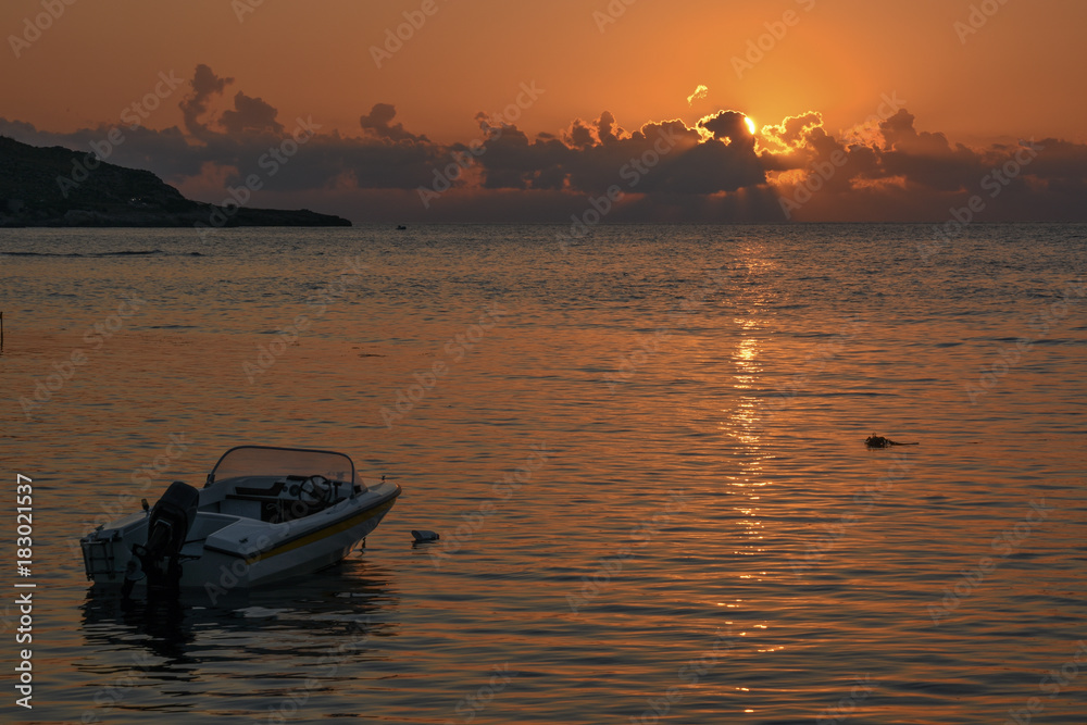 AThe motor boat at sunset