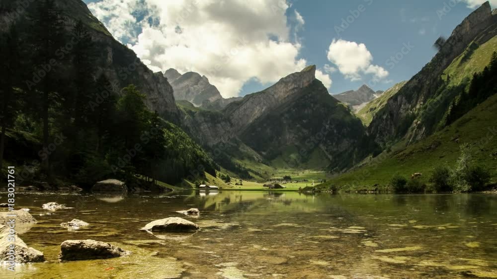 Time lapse clouds move over mountain lake Seealpsee in Alpstein Appenzell region switzerland travel swiss Alps