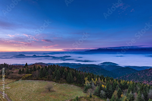 Fototapeta Naklejka Na Ścianę i Meble -  Misty sunrise landscape from Luban peak in Gorce mountains, Poland