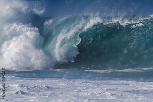 Giant breaking wave on the north shore of Oahu Hawaii at Waimea bay