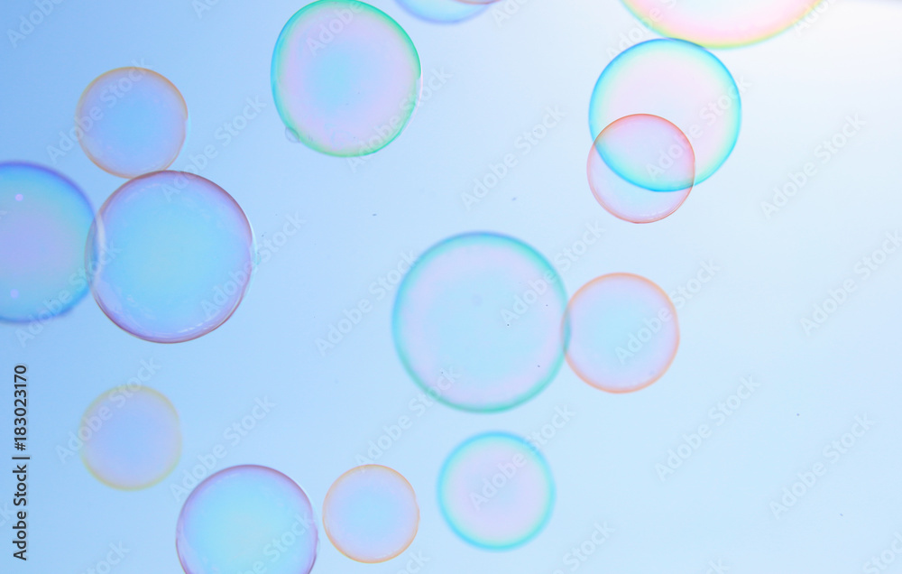 Soap bubbles floating in the air against soft clouds and sky. filtered image. selective focus.