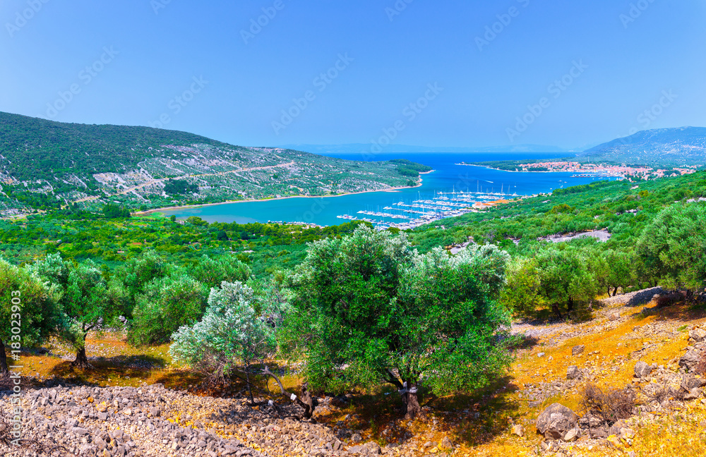 Naklejka premium Wonderful romantic summer afternoon landscape panorama coastline Adriatic sea. Boats and yachts in harbor at magical clear transparent turquoise water. Cres island. Croatia. Europe.