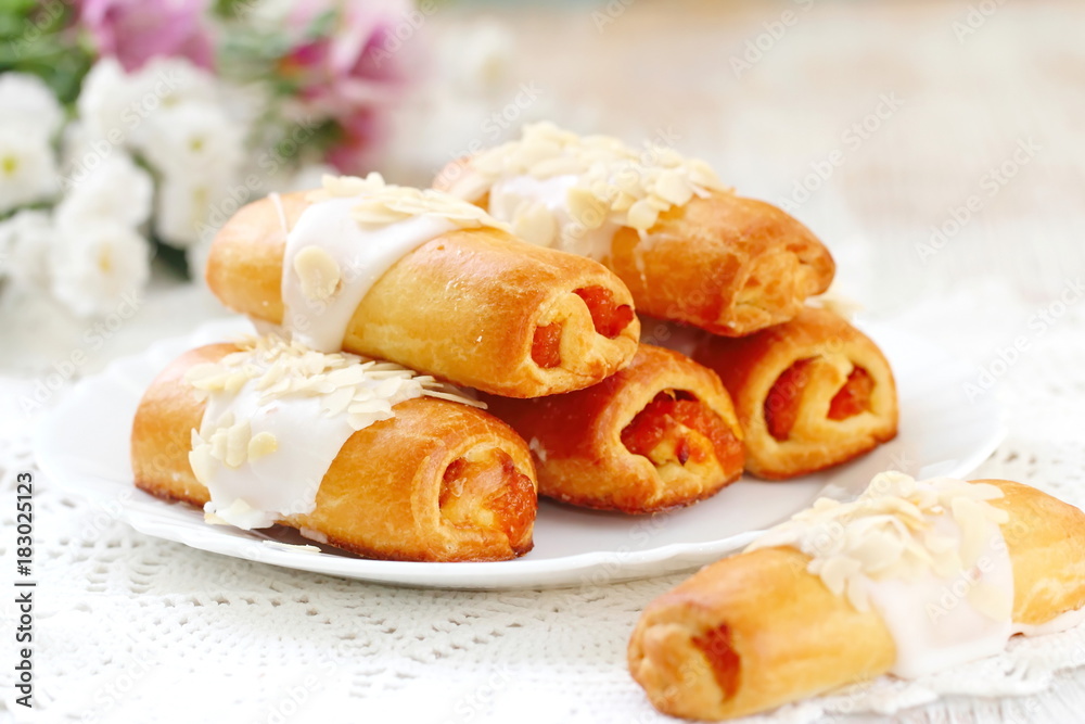 Roll with sweet cream, almonds and apricot jam