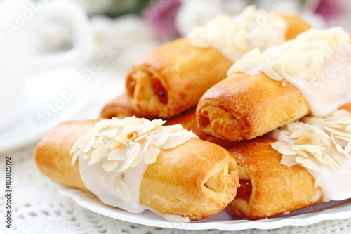 Roll with sweet cream, almonds and apricot jam
