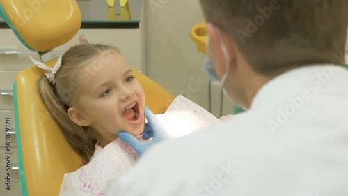 A dentist is treating the teeth to the child.