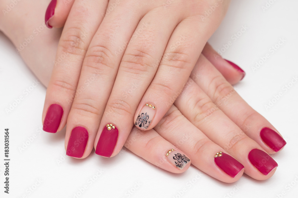 Closeup of hands of a young woman with red manicure on nails Closeup of hands of a young woman with red manicure on nails