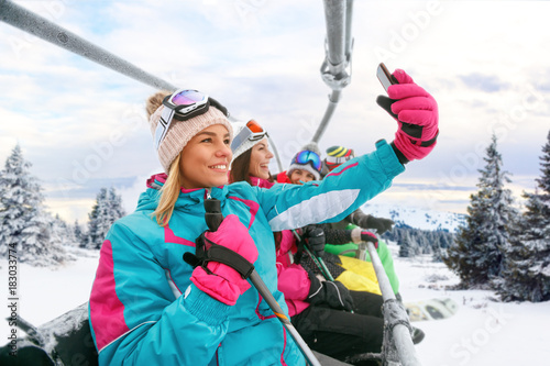 friends skiers enjoying in the slopes and making selfie