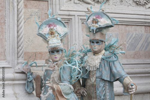 Venice Carnival masks in turquoise and peach Venetian costumes