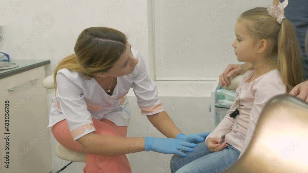 A little girl is at the dentist. A little girl is at the dentist.