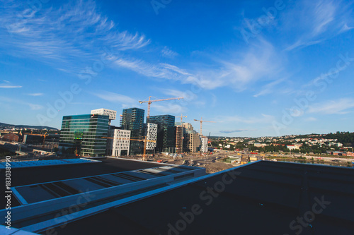 View of Oslo city, capital of Norway, with Sentrum borough, new district and harbour, view from Oslo Opera House, Eastern Norway © tsuguliev