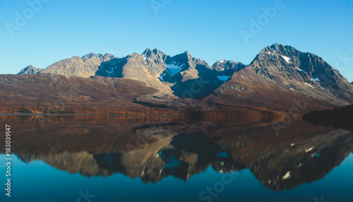 Beautiful vibrant summer view of Norwegian mountains and fjord reflection, Lyngen Alps, Finnmark county, northern Norway